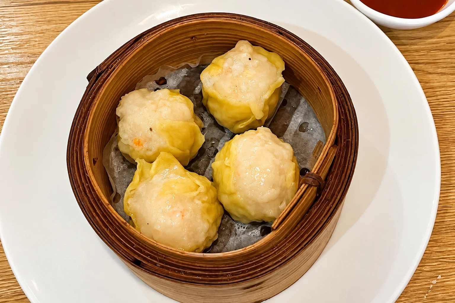 V2. Shrimp bites in a bamboo steamer basket, on a white plate